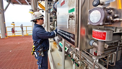 Worker checking equipment aboard the Tahiti deepwater platform at Tahiti field, offshore United States, Gulf of Mexico.